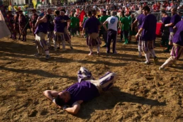 Calcio Storico Fiorentino: a calciante is thrown to the sand during a one-on-one duel