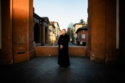 Easter lockdown Bologna: a lone figure walking beneath the empty porticoes during Covid-19 restrictions