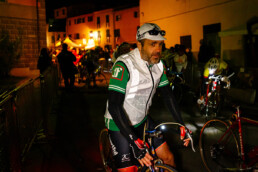 L'Eroica vintage cycling rider with front lamp during the pre-dawn departure